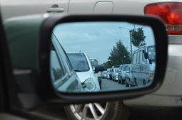 Automobiles in the reflection of a side view mirror