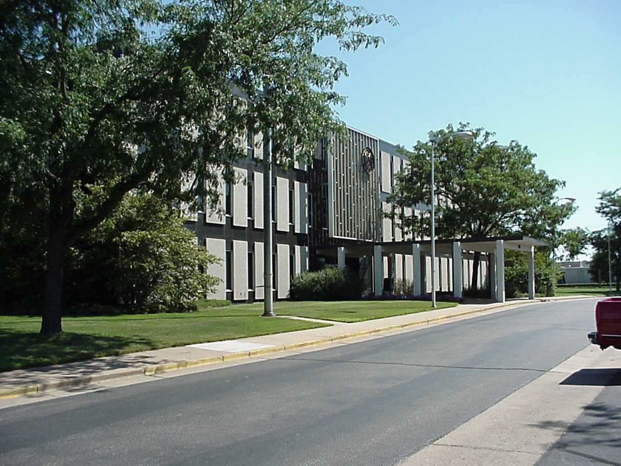 A front-side view of the Eau Claire State Office Building with a few trees in the foreground.